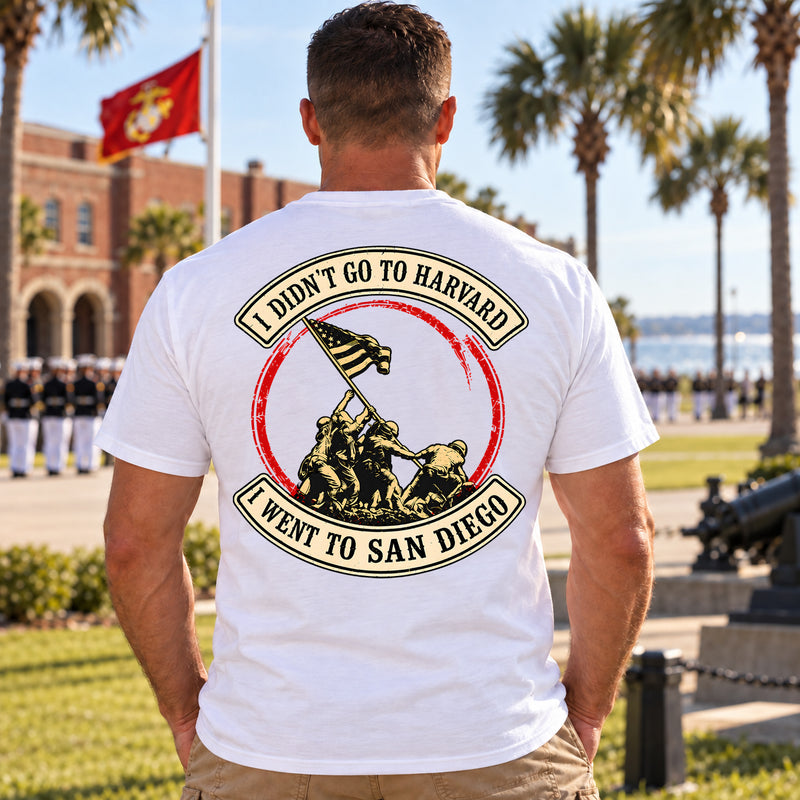 Man wearing a white San Diego custom year veteran T-shirt, back print view, outside a brick building