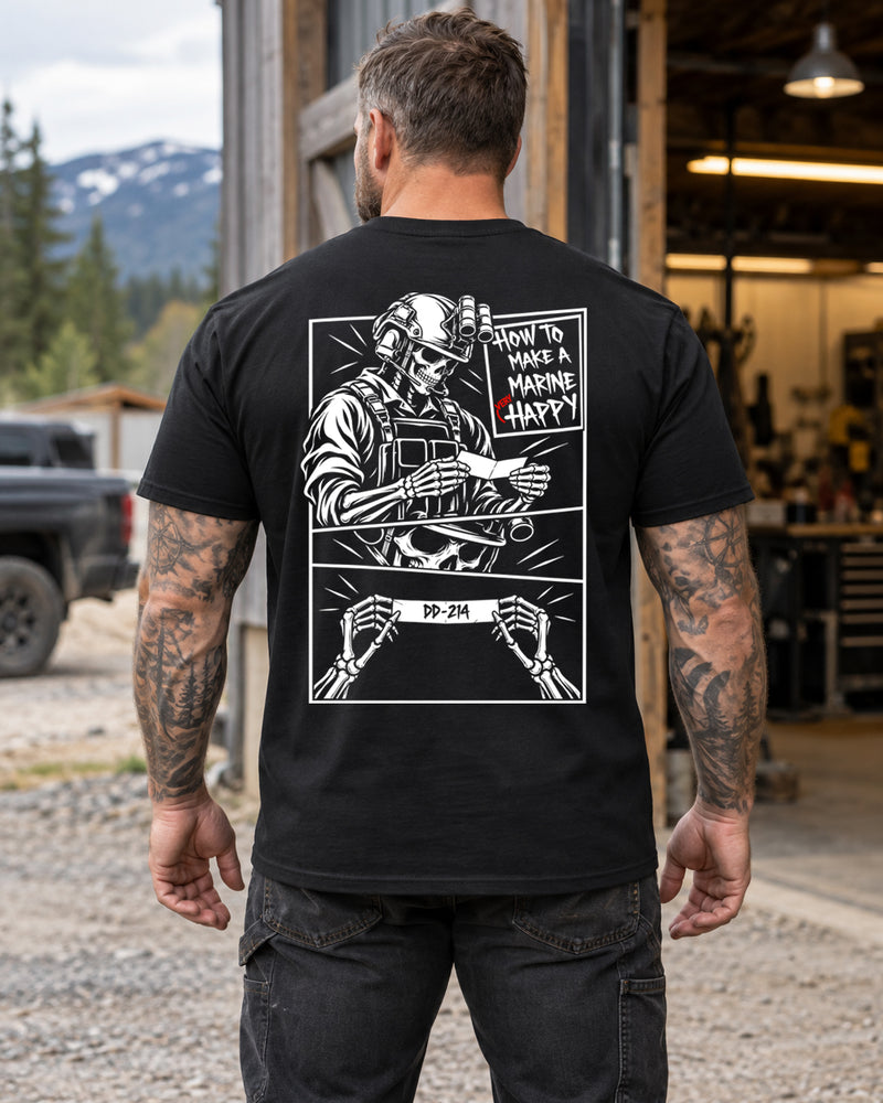 Man wearing a black How to make a marine happy marine veteran T-shirt, back print view, outside an open workshop garage