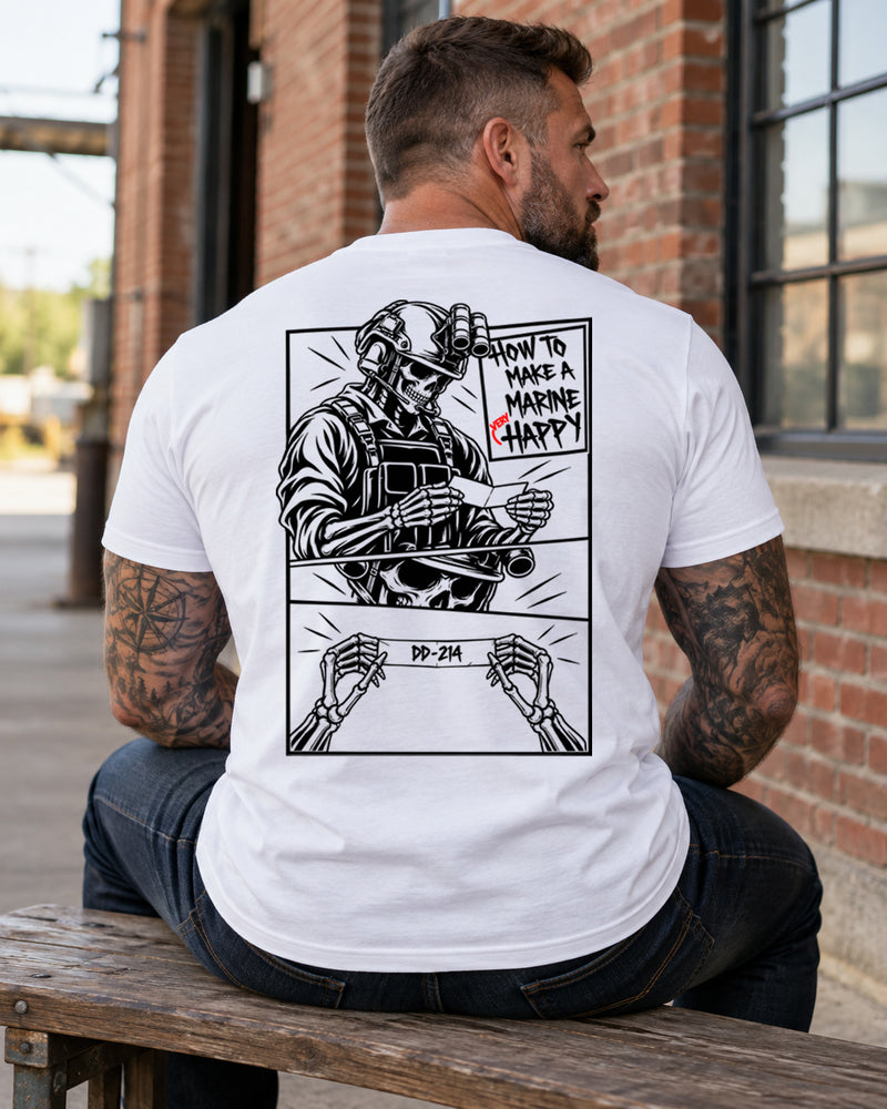 Man wearing a white How to make a marine happy marine veteran T-shirt, back print view, bench by a brick warehouse