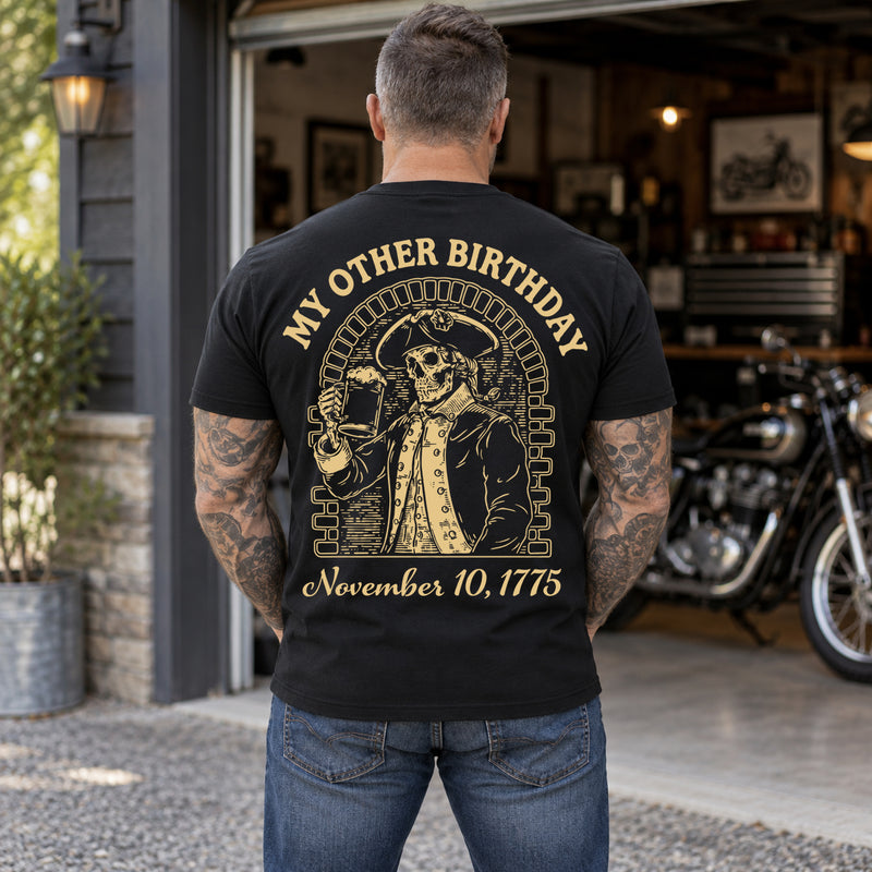 Man wearing a black My Other Birthday custom year veteran T-shirt, back print view, open garage with a motorcycle inside