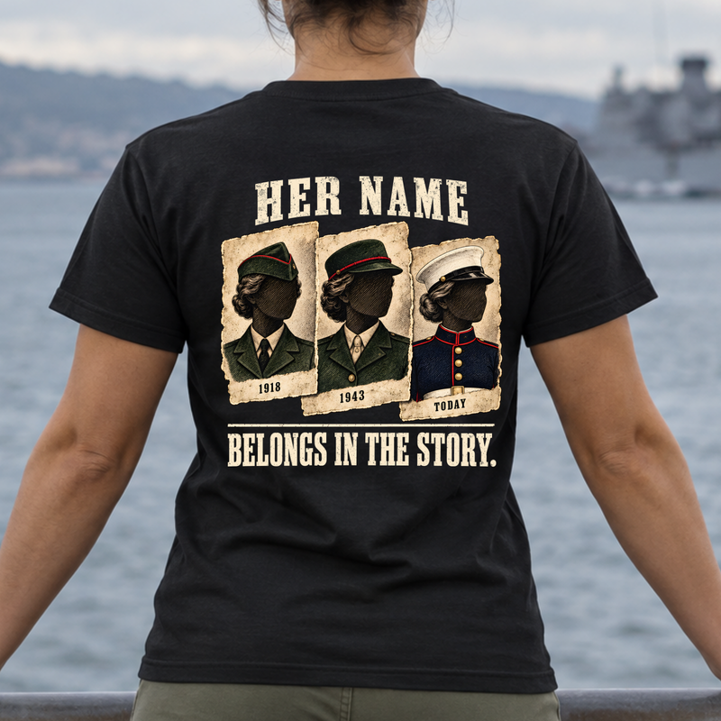 Woman wearing black Her Name Belongs in the Story Marine t-shirt outdoors by water