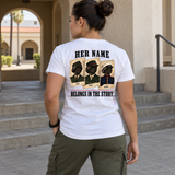 Woman wearing white Her Name Belongs in the Story Marine t-shirt near building archway