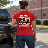 Woman wearing red Her Name Belongs in the Story Marine t-shirt standing by pickup truck