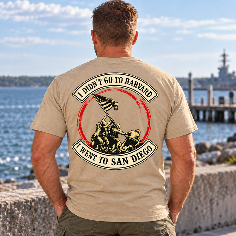 Man wearing a sand San Diego custom year veteran T-shirt, back print view, on the waterfront