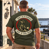Man wearing a military green San Diego custom year veteran T-shirt, back print view, by the harbor