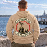 Man wearing a sand San Diego veteran hoodie, back print view, on the waterfront