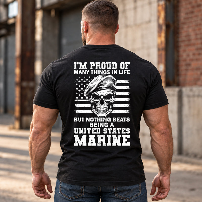 Man wearing a black Being A Marine custom year veteran T-shirt, back print view, Industrial alley by brick warehouse