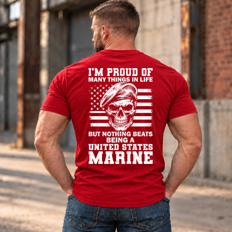 Man wearing a red Being A Marine custom year veteran T-shirt, back print view, Industrial alley with weathered brick walls