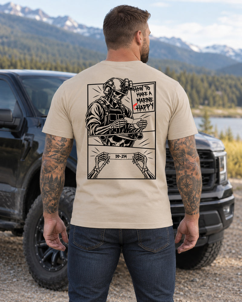 Man wearing a sand How to make a marine happy marine veteran T-shirt, back print view, mountain lake beside a pickup truck