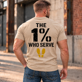 Man wearing a sand The 1% veteran T-shirt, back print view, brick warehouse alley