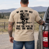 Man wearing a sand We are the men veteran T-shirt, back print view, by a pickup truck near mountain pasture