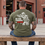 Man wearing a military green We Run Towards the Gunfire custom year veteran T-shirt, back print view