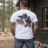 Man wearing a white We Run Towards the Gunfire custom year veteran T-shirt, back print view